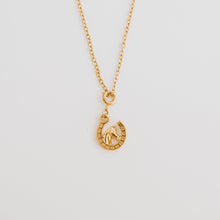 Load image into Gallery viewer, This horseshoe necklace with horse in the middle is the perfect cowgirl necklace. Available in 18k gold pvd stainless steel.