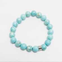 Load image into Gallery viewer, A turquoise beaded bracelet is a piece of jewelry composed of strung, greenish-blue to pale blue mineral beads, often featuring dark veining or "matrix". Prized for thousands of years, these bracelets symbolize protection, good fortune, and connection to the sky and water, frequently used in many cultures.