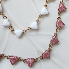 Load image into Gallery viewer, Enamel white and pink option colors on the hearts with 18K Gold with a Stainless Steel Base to ensure it is hypoallergenic and tarnish-resistant with water and sweat.