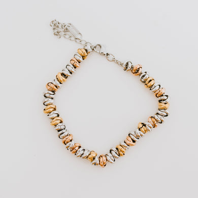 Like a bouquet of flowers that is composed of a variety of colors so is the Bouquet Bracelet. It is made up of ringlets of Gold, Silver, and Rose Gold. The perfect bracelet to tie in when mixing different color metals in one look.