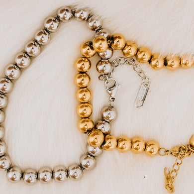 Both silver and gold echo bracelets in the large size.