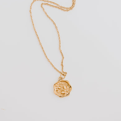 This floral stamp necklace, like a wax stamp gives it that vintage vibe with elegance and femininity that goes well with any look. 
18k gold pvd stainless steel.