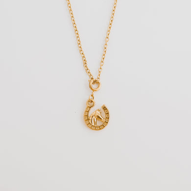 This horseshoe necklace with horse in the middle is the perfect cowgirl necklace. Available in 18k gold pvd stainless steel. 